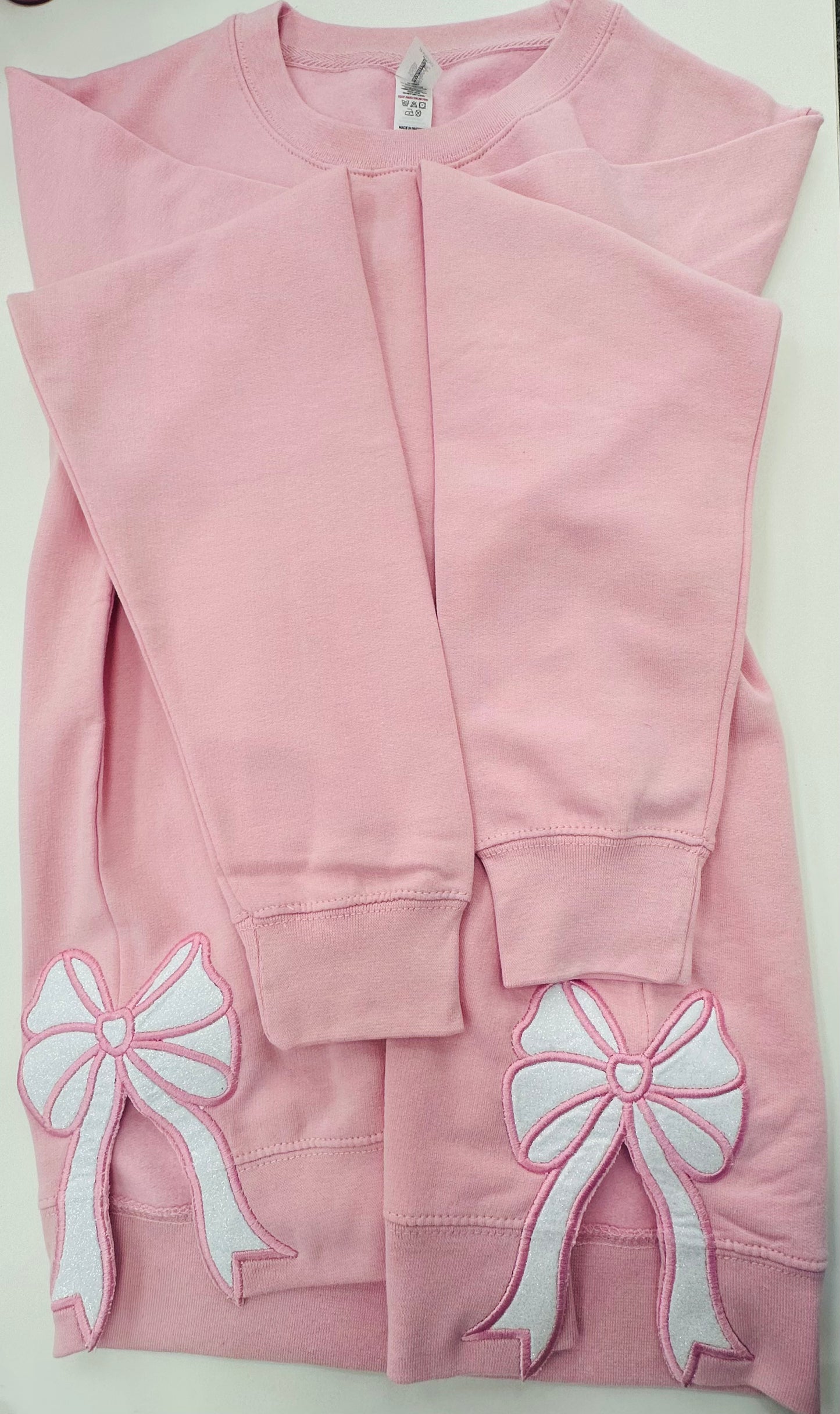 Pink sweatshirt with bows on the sides