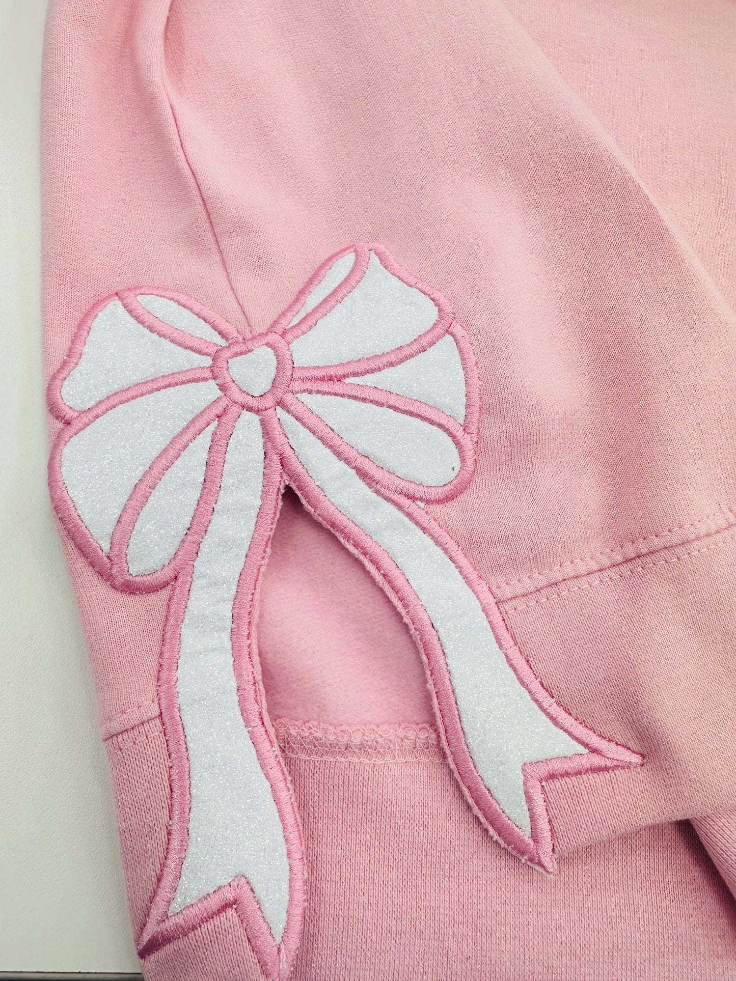 Pink sweatshirt with bows on the sides