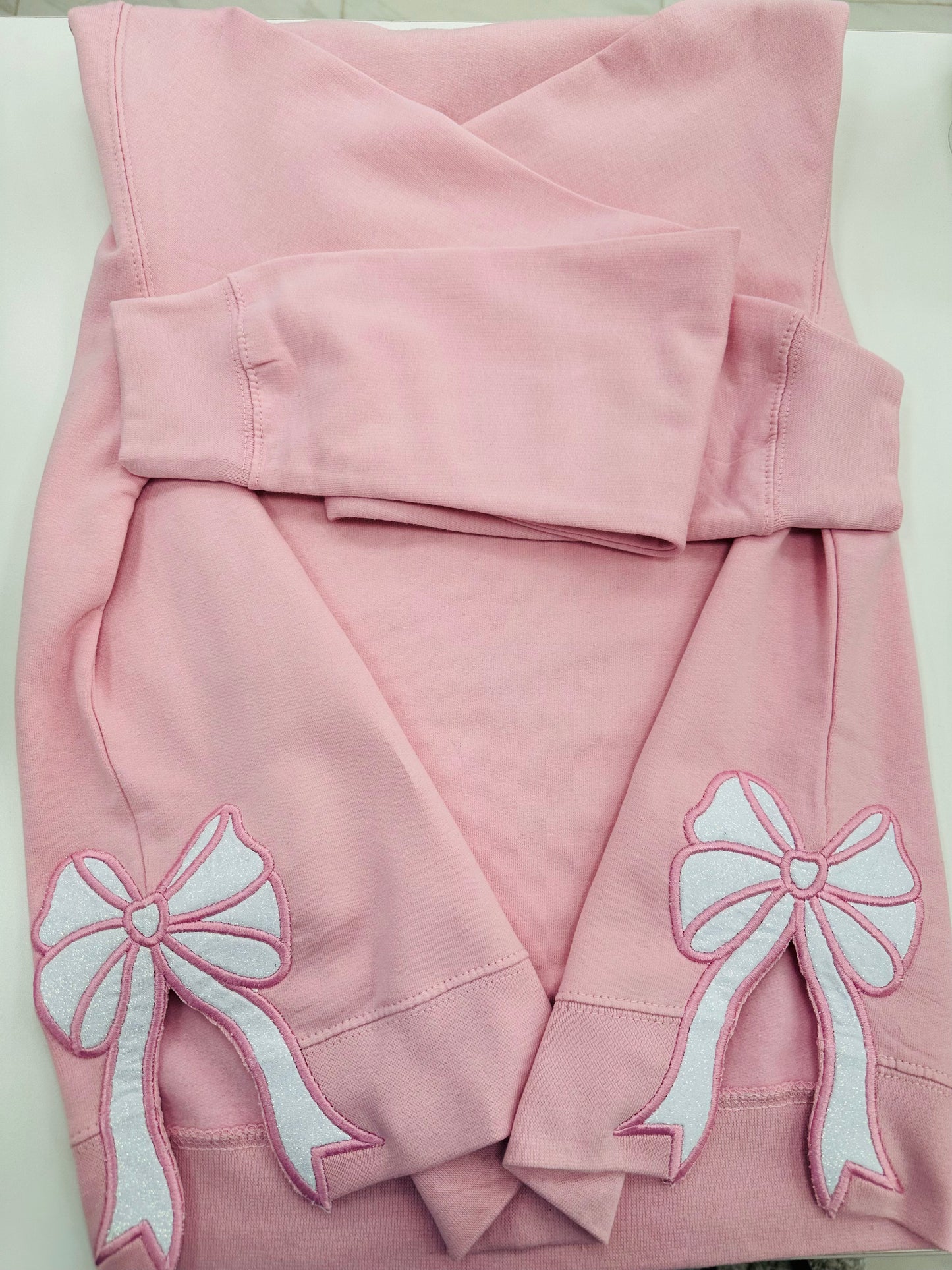 Pink sweatshirt with bows on the sides
