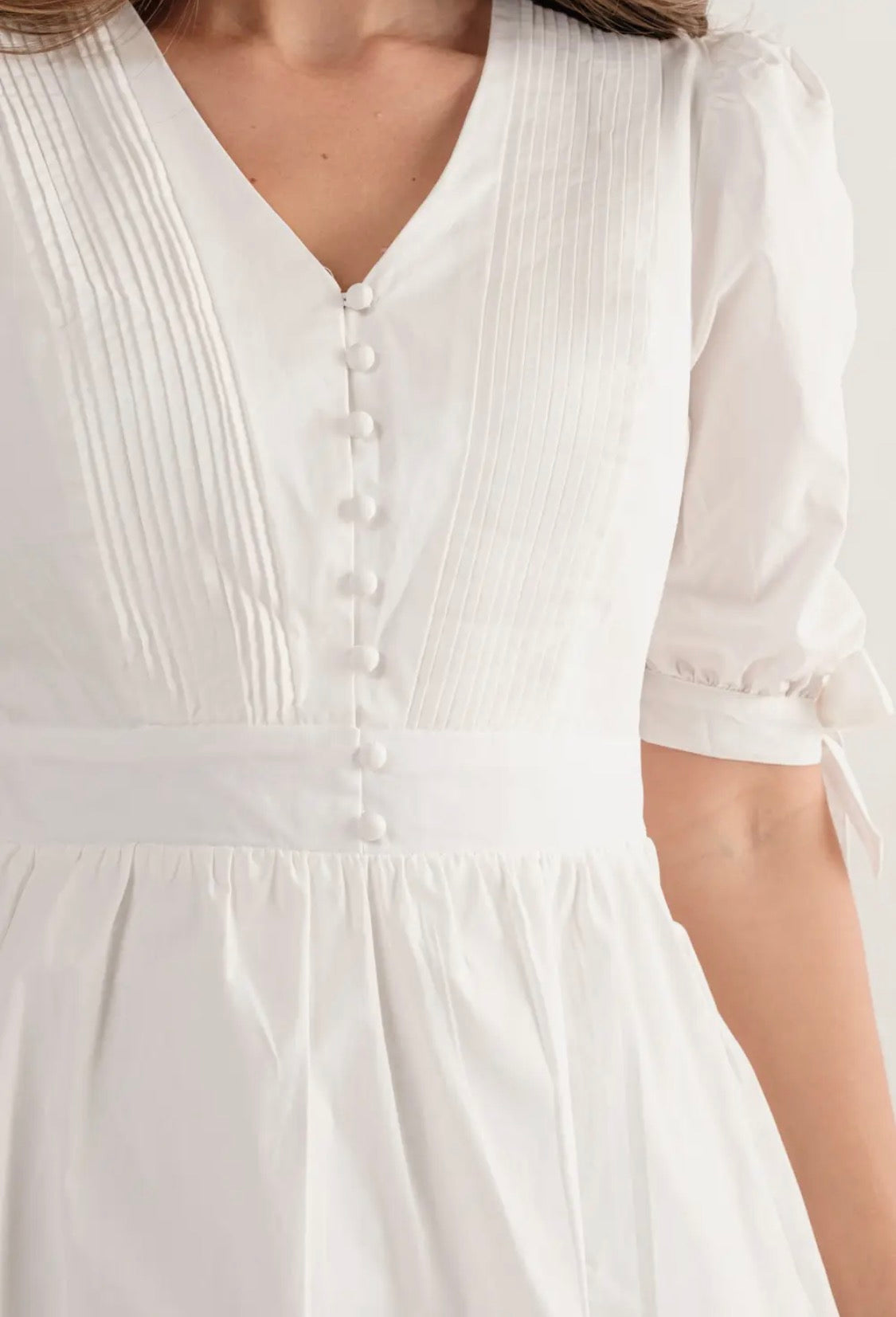 White dress bow tie on sleeve